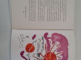 an open book with a picture of a flower on it