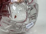 a clear glass vase with a red flower inside of it