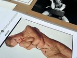 a lot of pictures on a table with a picture of a man