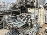 piles of steel pipes and poles stacked on top of each other