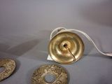 a gold object on the table next to two other objects