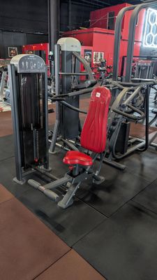 a gym with a lot of machines in the room