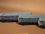three toy trains sitting on a table next to each other