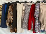 a lot of clothes that are hanging on a rack