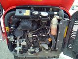 a small engine in the back of a red truck