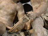 a statue of a boy with a gun in his hand
