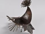 sculpture of a bird on a stand with a white background