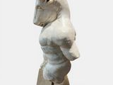 marble statue of a man with a horse head on a pedestal