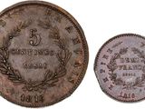 a close up of a coin with a wreath on it