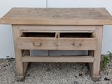 a wooden table with two drawers on top of it