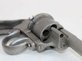 a gun that is sitting on a white surface