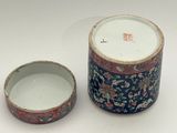 a small container with a lid and a smaller container with a lid