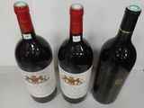 three bottles of wine sitting next to each other on a table