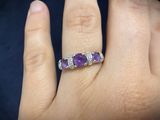 a close up of a person ' s hand with a ring on it