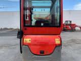 an image of a red forklift parked in a parking lot