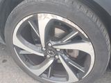 a close up of a car ' s tire on the street