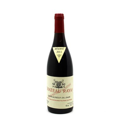 a bottle of red wine sitting on top of a white table