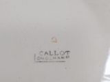 a close up of a white plate with a blue design on it