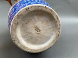 a blue and white vase sitting on a table