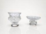 two glass vases sitting next to each other on a white surface