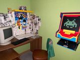 a desk with a computer and a chair in a room