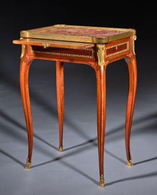 a small wooden table with a marble top on a grey surface