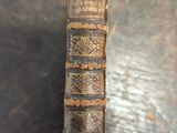 an old book sitting on top of a wooden table