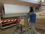 a machine that is working on a piece of wood