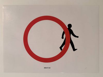 a picture of a red and white sign with a man walking in a circle