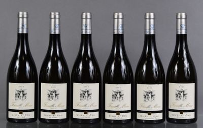six bottles of wine are lined up in a row on a table