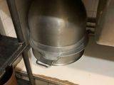 a large metal ball sitting on top of a shelf in a kitchen