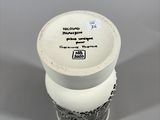 a white vase with a black and white design on it