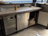 an outdoor kitchen with stainless steel appliances and a sink