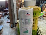several rolls of insulation sitting on top of a table in a room
