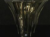 a close up of a glass vase on a black surface
