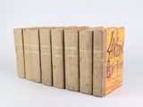six books are stacked on top of each other on a white surface