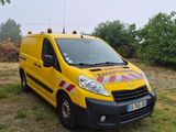 a yellow van that is parked in the grass