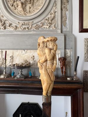 a statue of a woman holding a child on a table