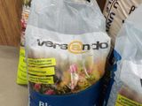 two bags of food sitting on the floor next to each other