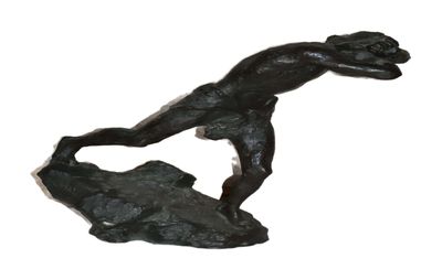 statue of a man on a surfboard on top of a rock