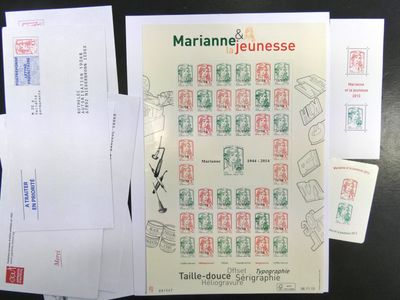 Plusieurs enveloppes, sur lesquelles sont apposés des timbres, sont posées sur une table.