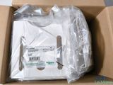 a box with a white shirt in it on a table