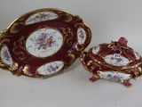 two pieces of porcelain ware are sitting on a white surface