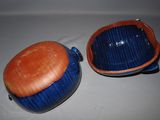 two blue and orange bowls on a white surface