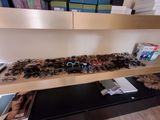 many pairs of glasses on a shelf in a room