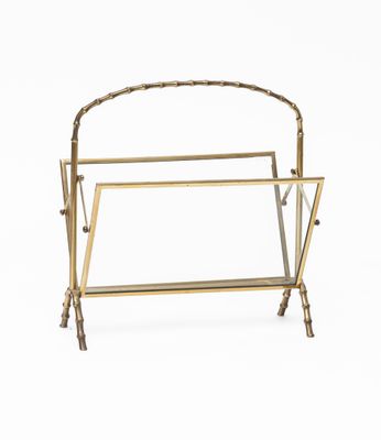 a brass magazine rack with a magazine holder on top of it