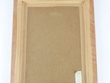 an empty wooden frame with a piece of paper on it