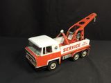 a red and white toy truck with a crane on it