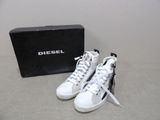 diesel sneakers in white and black with a box on the floor