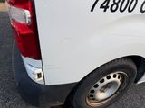 a white van parked in a parking lot next to a building
